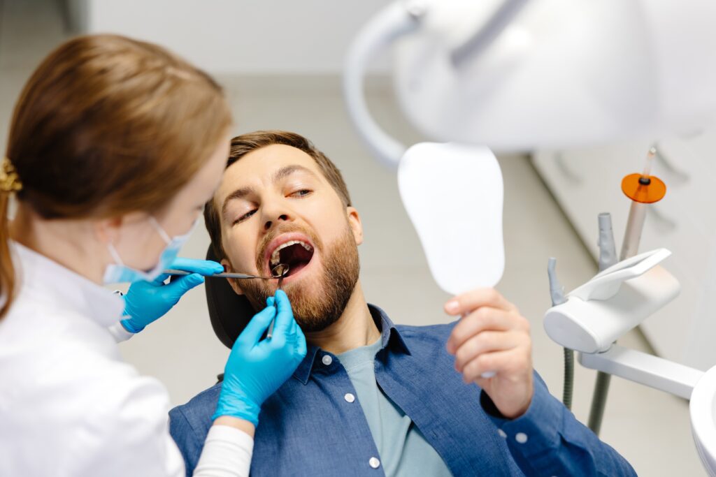 young man with beard getting a dental cleaning and exam in Houston